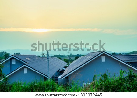 Top view roof of modern village with sunset sky, High voltage electricity infrastructure design to home electric lighting utility, Energy power equipment with digital smart home for future