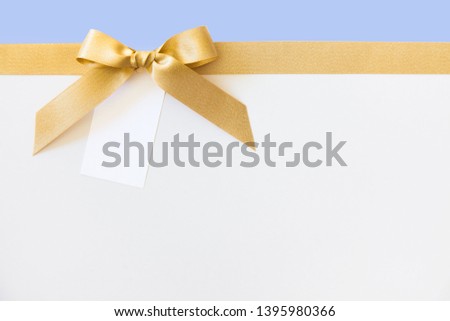 cross thin gold ribbon with bow, isolated on white
