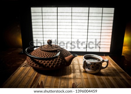 Tea concept. Japanese tea ceremony culture east beverage. Teapot and cups on table with bamboo and tradicional Japan ornament decor elements
