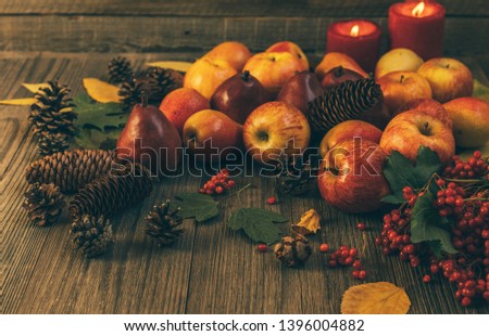 Autumn food background with apples, pine cones, spices, berries and fallen leaves with copy space for text. Autumn food backdrop. Selective focus.