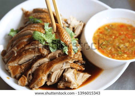 Pot-stewed duck with chilli sauce  on white plate in local restaurant of Thailand. This delicious menu is one of  the popular foods in Asia,best dishes to eat . 