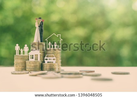 Sustainable financial goal for family life or married life concept : Miniature wedding couple, parent & child, a house or home, a car on rows of rising coins, depicts savings or growth for new family Royalty-Free Stock Photo #1396048505
