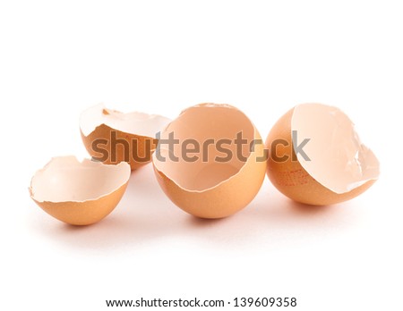 Broken egg shell composition over white background
