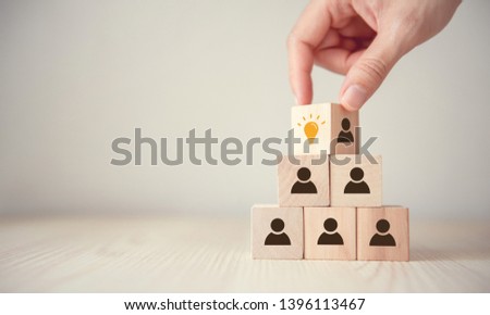Leader with idea and innovation, Woman hand flips cube with icon light bulb and human symbol. Royalty-Free Stock Photo #1396113467