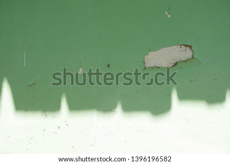 Green wall paint peeled off.