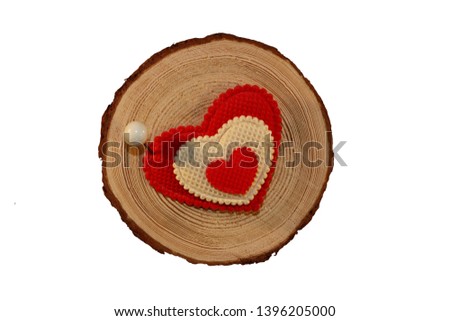beautiful red heart is nailed to a wooden saw cut on a white background