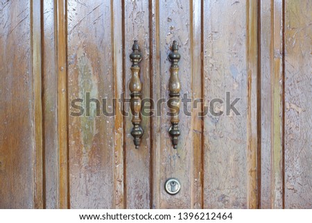 Iron door handle on the teak door.