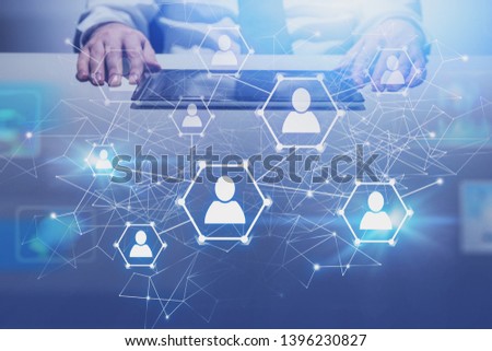 Man with digital tablet at office table with double exposure of social network interface. Concept of recruiting and human resources. Toned image double exposure