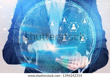 Businessman with digital tablet using social media and people network holograms in global world. Toned image double exposure