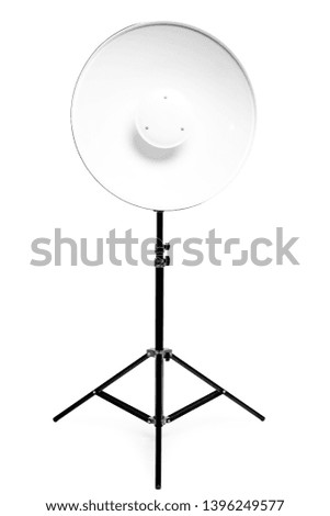 Round metal photo flash on a rack in a photo studio on a white background close-up