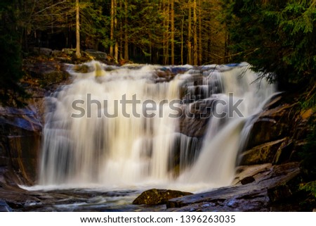 Vivid view of 'Mumlavský vodopád' waterfall in Harrachov, Czech Republic. Beautiful scenery, blurred, soft water. 