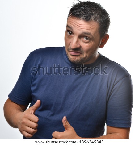 Potrait of a young man isolated on white wearing a blue t-shirt.
