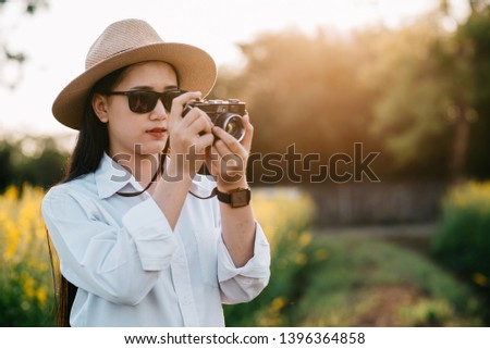 young Woman photographer with camera
