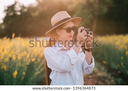 young Woman photographer with camera
