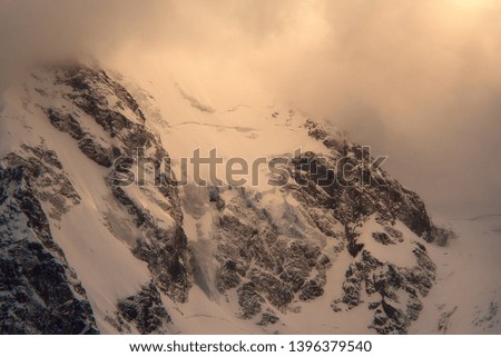 mountain slopes covered with snow with glaciers in the evening at sunset. Kabardino-Balkaria, Russia