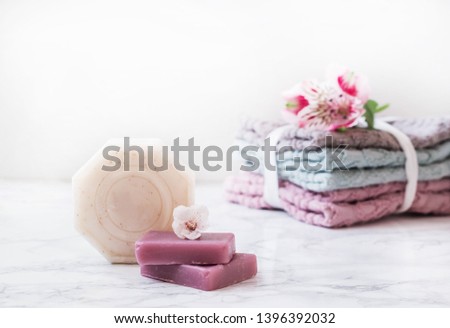 natural soap. handmade soap. Stack of fresh towels with flowers on white background. spa treatments