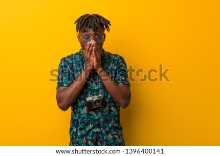 Young black rasta man wearing a vacation look scared and afraid.