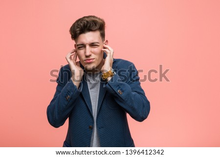 Young business natural man covering ears with his hands.