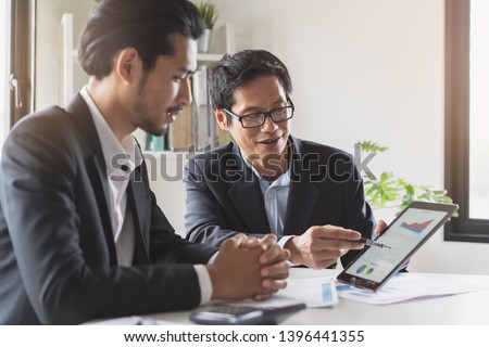 financial advisory services. Asian advisor showing plan of investment to clients in the consultancy office. Royalty-Free Stock Photo #1396441355