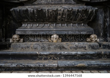 Ancient Christian church of Saint Mary from Krakow city in Poland built in gothic style.Marble stone skull statue in exterior of old catholic temple in Europe.