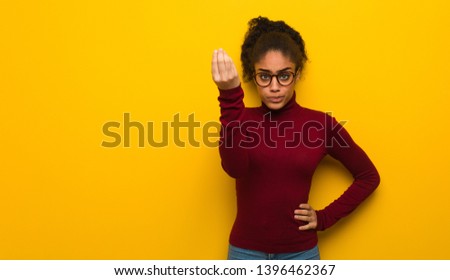 Young black african american girl with blue eyes doing a typical italian gesture