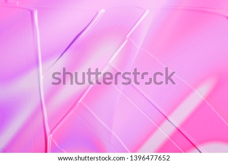 vaporwave style texture background: neon holographic pink funky paint texture. Close up, flat lay.