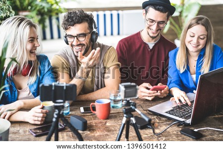 Young happy friends sharing content on streaming platform with digital web camera - Modern lifestyle concept with smart millenial guys and girls having fun vlogging live feeds on social media networks Royalty-Free Stock Photo #1396501412