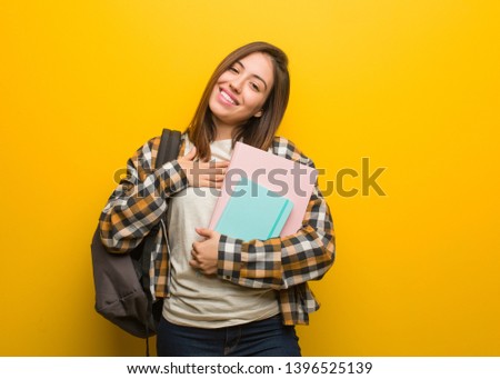 Young student woman doing a romantic gesture