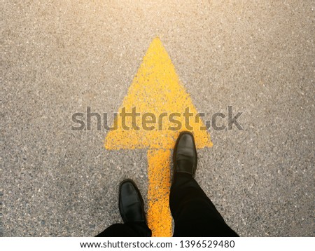 Feet and arrows on road.  Royalty-Free Stock Photo #1396529480