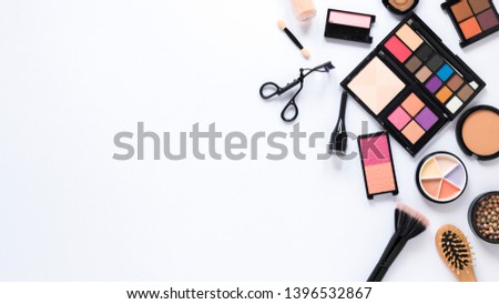 makeup cosmetics, brushes and other essentials on white background. flat lay frame composition with copyspace