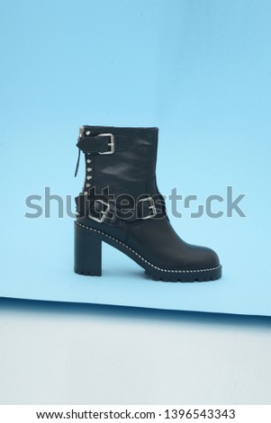 
Black boots on blue background