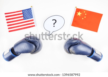 Creative top view flat lay of Two boxing gloves with China and USA flag bubble lightbox with question mark and copy space white background in minimal style. Concept of trade war between USA and China