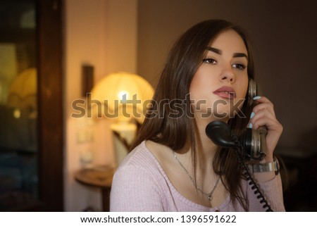 Girl talk with someone on retro telephone
