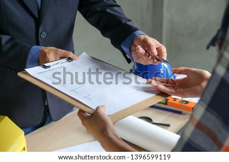 Businessman or agent send pen to team or client about inspection checklist report and prepare to sign contract agreement
