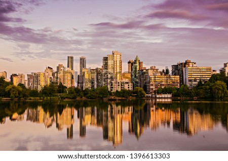 City skyline with perfect reflection in the water during colorful beautiful sunset, Downtown Vancouver and Lost Lake