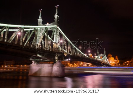 Freedom Bridge or Liberty Bridge at night in Budapest, Hungary. Long exposure with light trails.