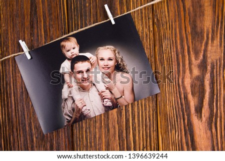 Family day concept. Photo of a young family on a wooden background with space for text