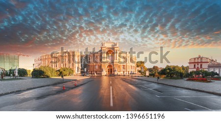 Panoramic view of the central part of the city of Odessa with a beautiful building of the Opera and Ballet Theater and the adjacent park on the background of the stunning sunset sky with feather