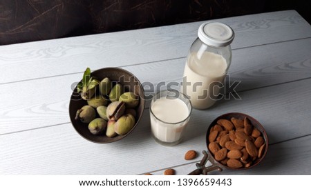 Milk and almond with leaf background, healthy food. on a white background