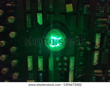 Green light bulbs on electric circuits.
