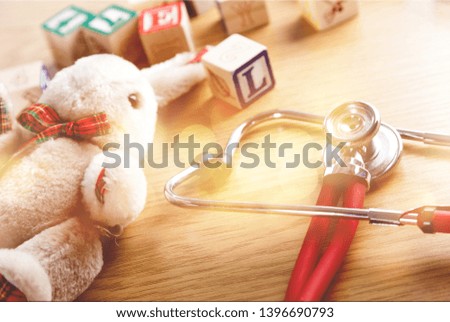 Stethoscope toys and box text on wooden