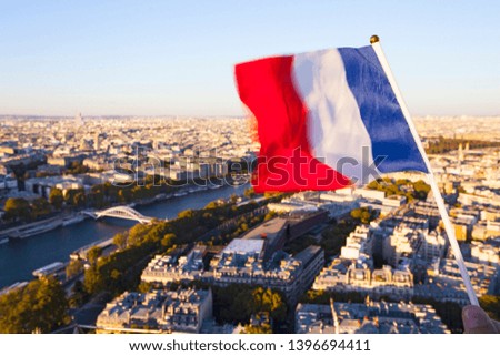 The Flag of France over the Paris city top view  from Eiffel tower at sunset time