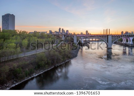 A Wide Angle Cityscape Shot of Minneapolis and Bridges Spanning the Mississippi River during a Beautiful Spring Sunset