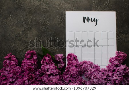 may calendar with flowers. Flat lay calendar. Top view. Beautiful lilac flowers.