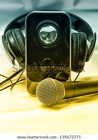 Vintage photo of microphone, headphones and speaker
