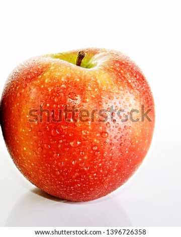 apple on a table with water dripping from it no people stock photo