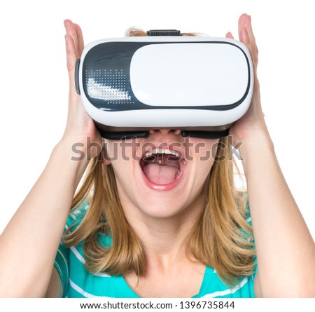 Amazed woman wearing virtual reality goggles watching movies or playing video games, isolated on white background. Surprised girl looking in VR glasses. People experiencing 3D gadget technology.