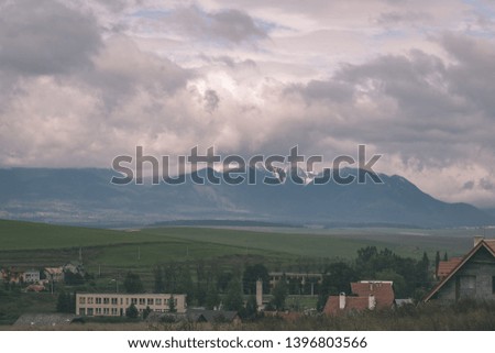 country village rooftops in Slovakia with mountains in background - vintage retro look