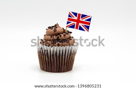 creamy chocolate swirl cupcake with a British Union Jack flag decorated toothpick isolated on white