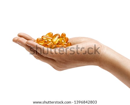 Many capsules Omega 3 in man's hand isolated on white background. Close up. High resolution product. Health care concept
